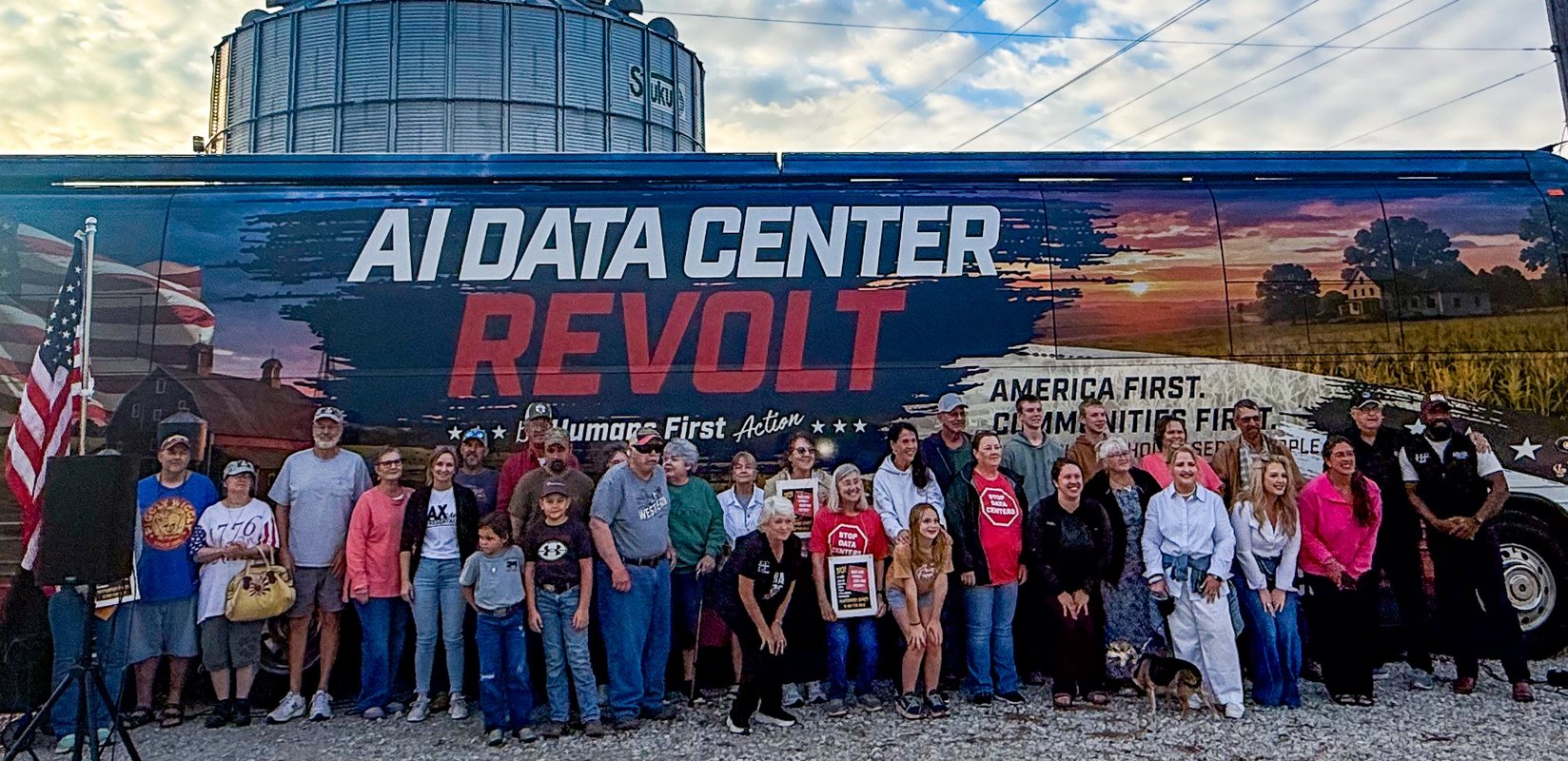 Montgomery County residents gather with Humans First organizers in front of the AI Data Center Revolt Tour bus Tuesday at the Ridgley farm near Jonesburg. (Photo by John Grady)