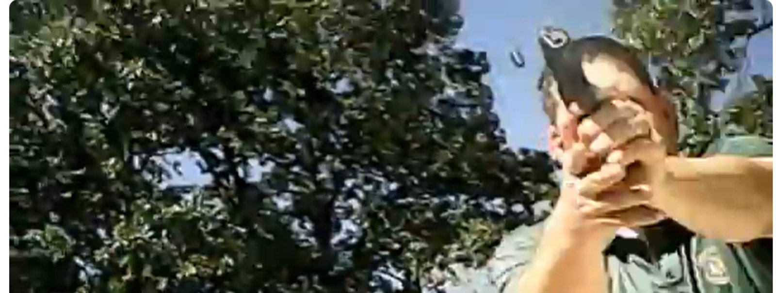 A frame from Jeffrey Weinhaus’s watch camera video shows a Missouri State Highway Patrol trooper aiming his handgun during the September 11, 2012 encounter near St. Clair. A spent casing is visible in the air above the trooper.